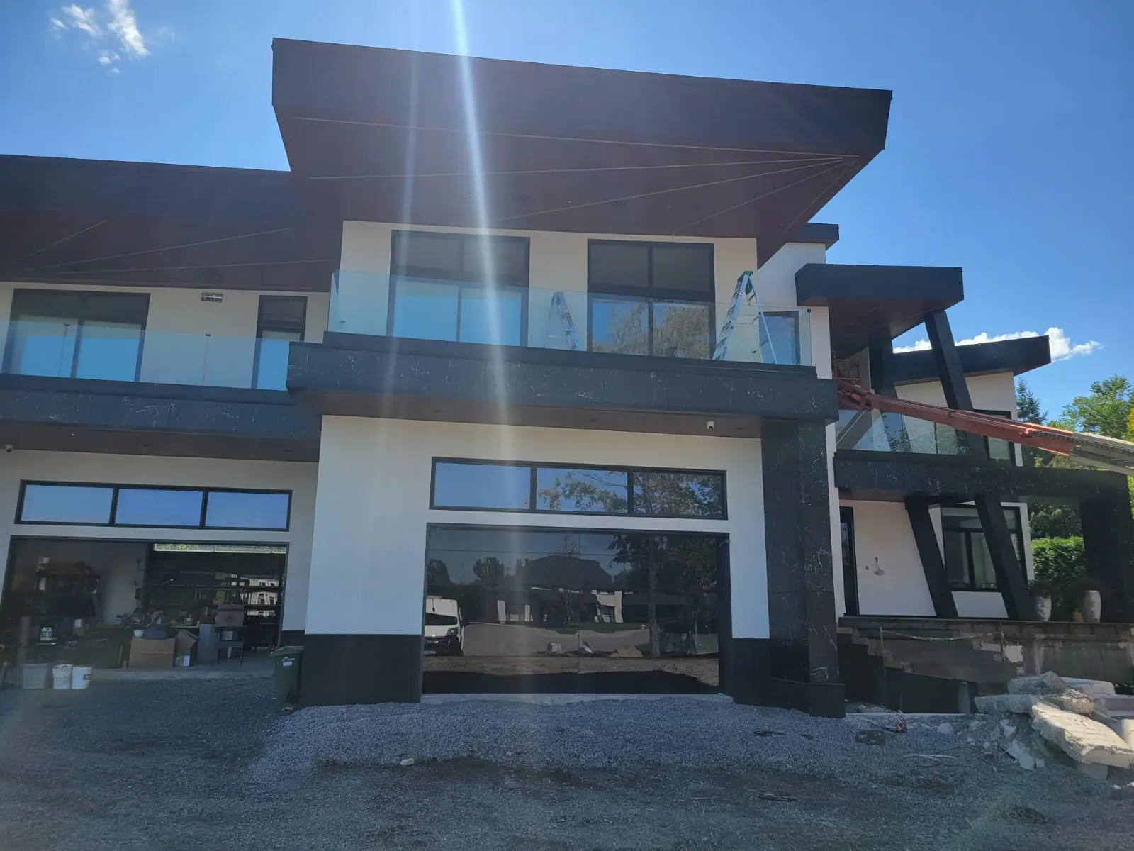 Modern custom home with a completed white stucco exterior