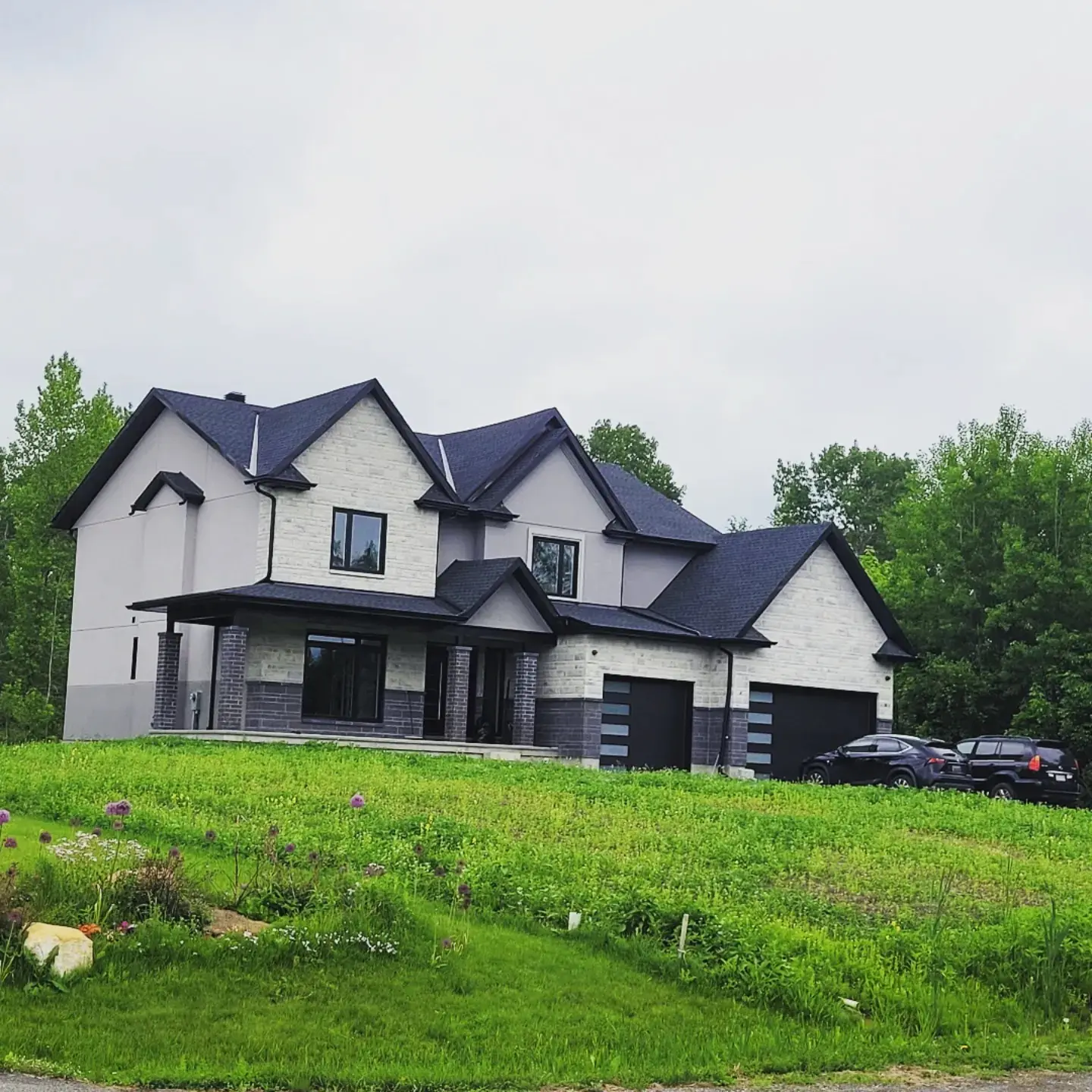 Large custom residence with a completed white and dark exterior