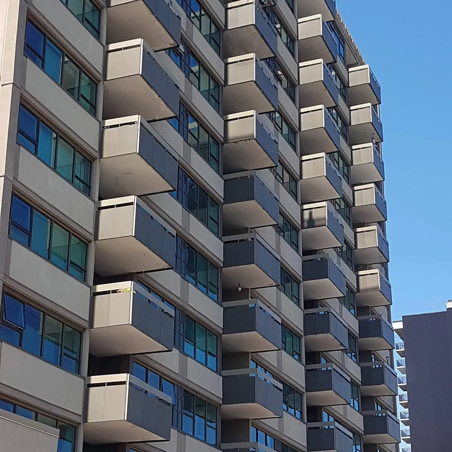 Multi-storey residential building with exterior finishing work
